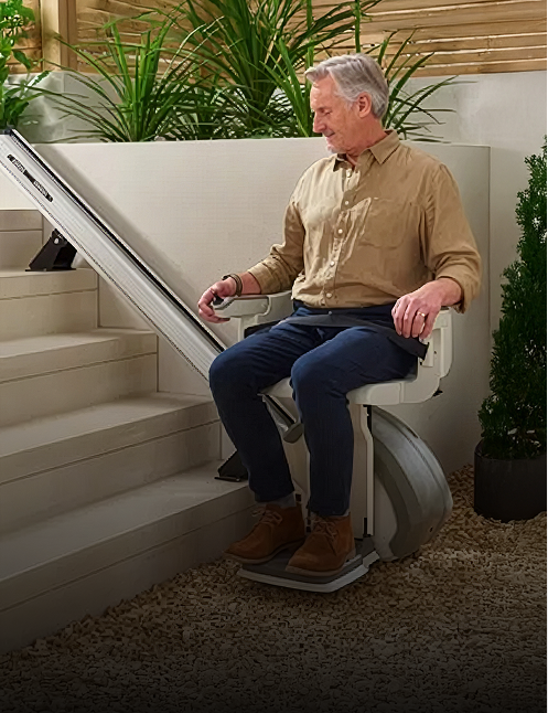 Man using outdoor stair lift in backyard